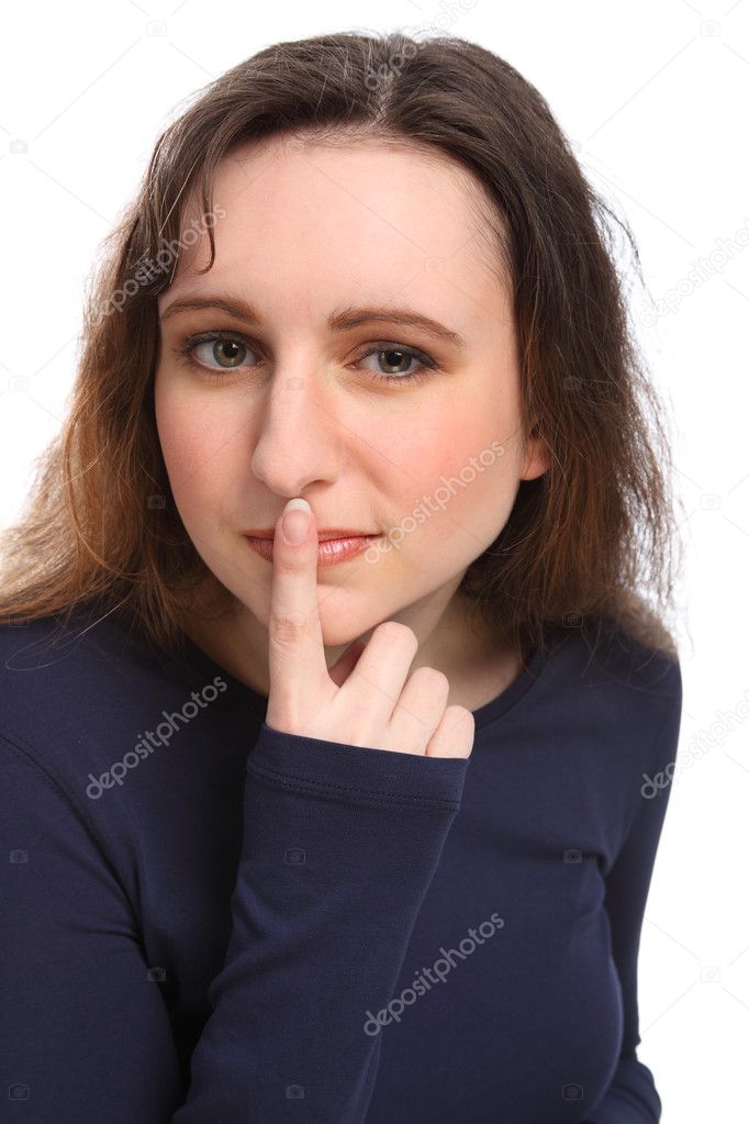 Beautiful young girl indicates keep quiet or keep a secret by holding a Beautiful young girl indicates keep quiet or keep a secret by holding a