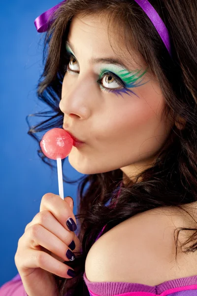 Girl licking lollipop by Viktor Levi Stock Photo Editorial Use Only