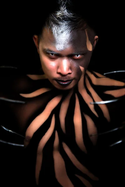 Male with Black Body Paint Wearing Claws on the Fingers