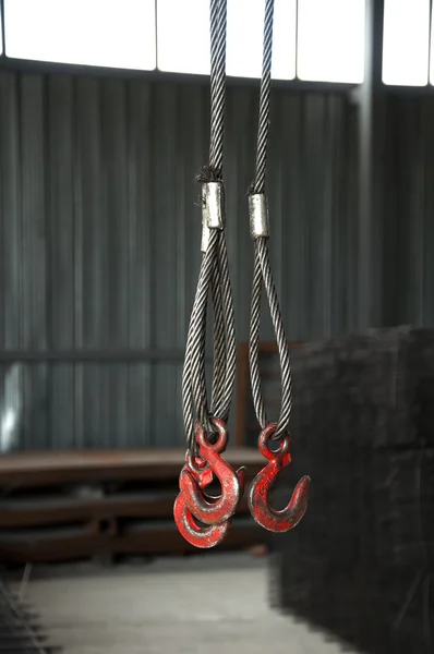 Three metal hooks with wire rope