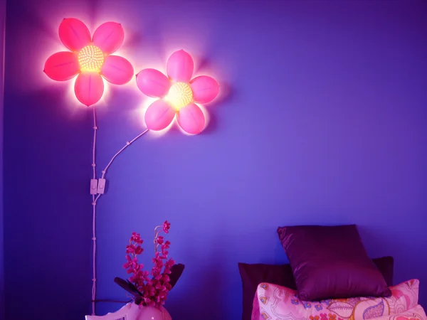 Vibrant purple bedroom with pink flower lights — Stock Photo #6509032