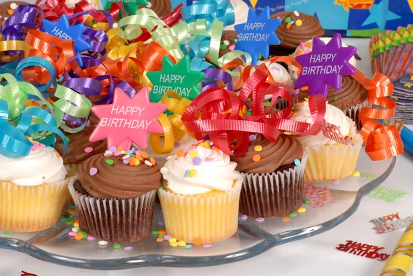 Closeup of a platter of cupcakes decorated with Happy Birthday t