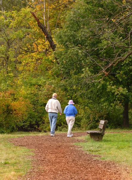 Senior citizen couple walking on path