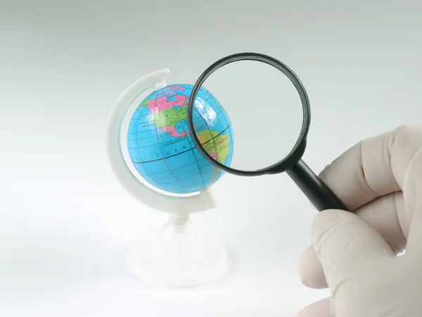 Earth globe & human hand