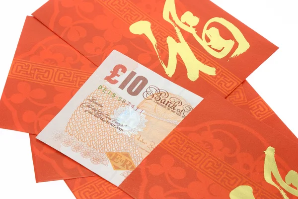 Chinese New year red packets and Bristsh currency notes