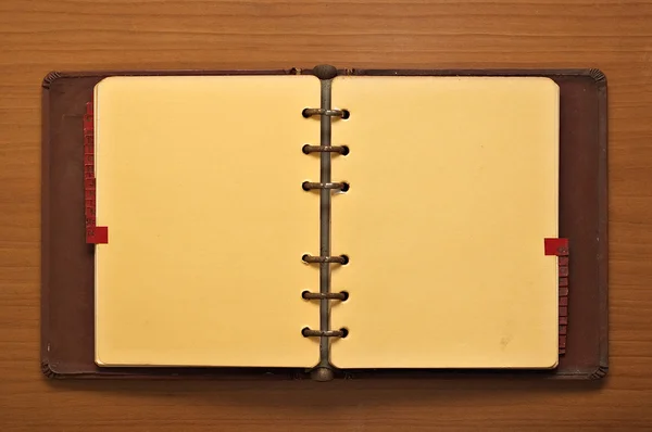 Leather bound journal on a wooden desk background
