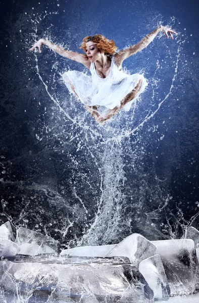 Jump of ballerina on the ice dancepool around splashes of water