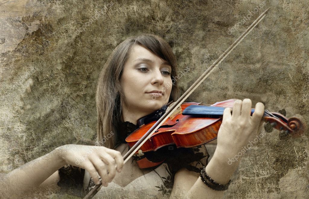 Beautiful Female Violinist Playing Violin On The Grunge Backgrou