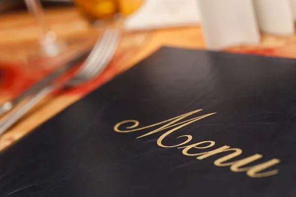 Menu & Cutlery on A Restaurant Table