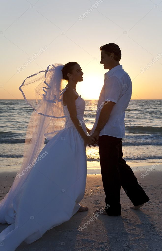 Wedding of a married couple bride and groom together at sunset on a 