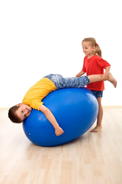 Kids having fun playing with a large rubber ball