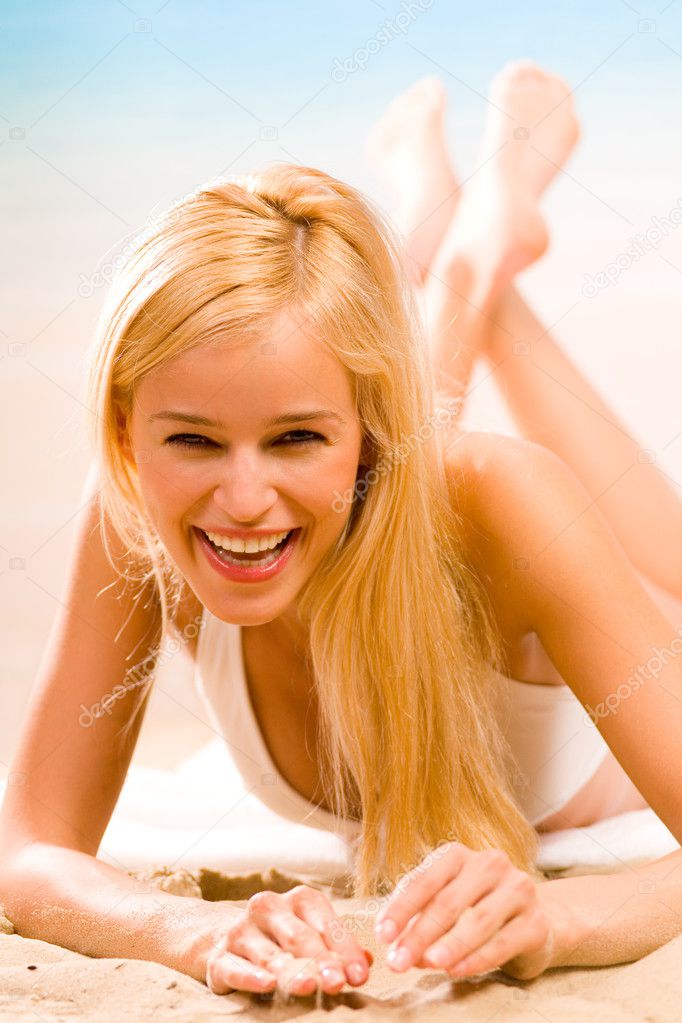 Young sexy beautiful tanned blond woman in white bikini on tropical sea 