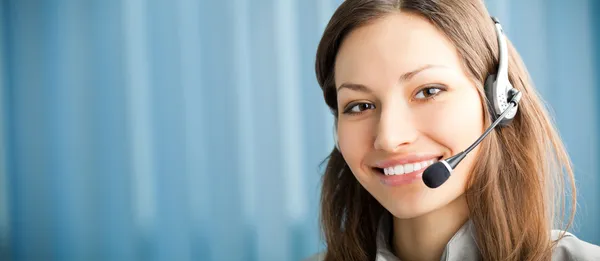 Portrait of happy smiling support phone operator in headset at w
