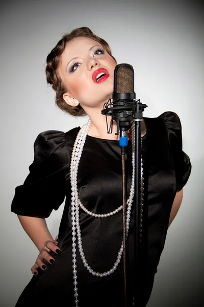 Attractive brunette woman with a retro microphone