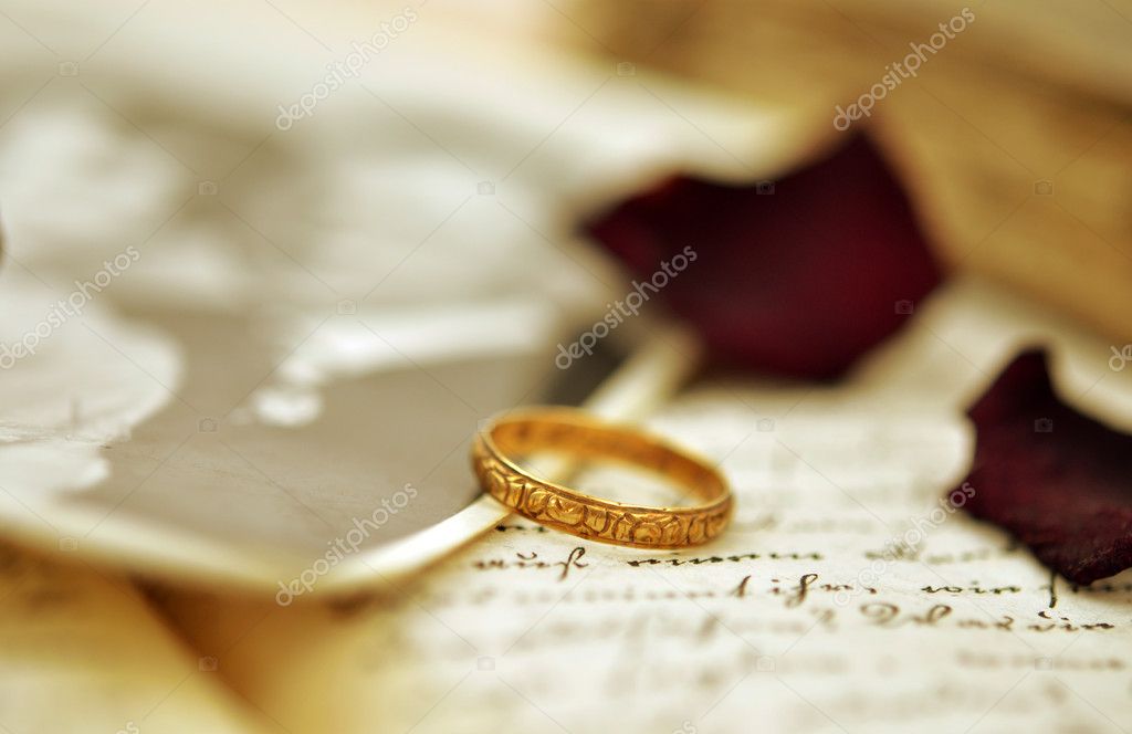 Old wedding ring on an old diary and vintage photo