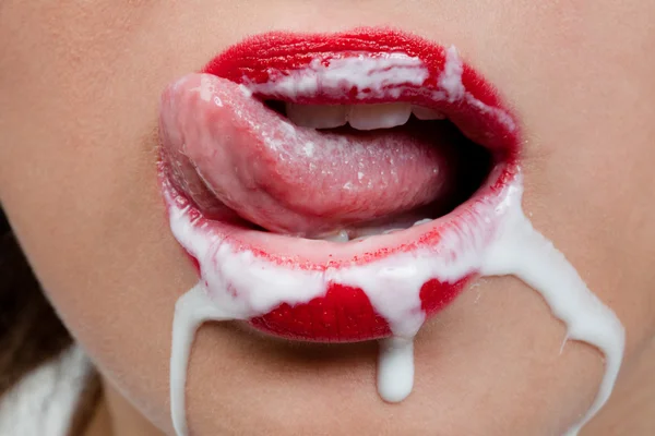 Girl licking her lips covered with white substance