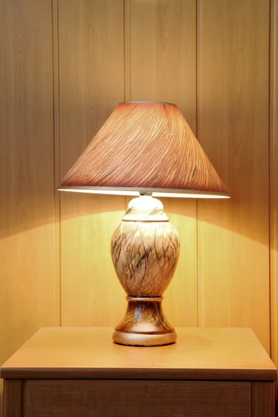 A small lamp on the nightstand