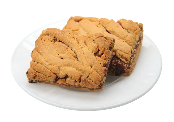 Cookies på en vit platta, isolerade — Stockfoto
