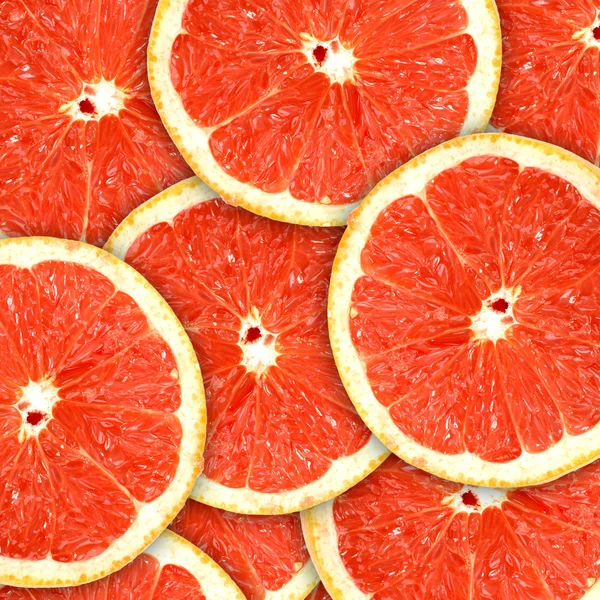 Фон с цитрусовыми фруктами из ломтиков грейпфрута — стоковое фото