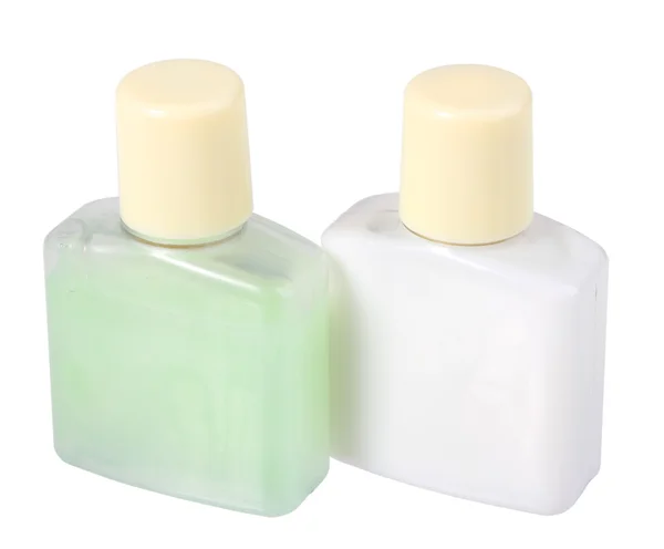 Два косметических крема в прозрачных бутылках — стоковое фото