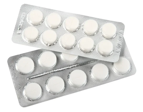 Bílé pilulky v kovové blistr — Stock fotografie