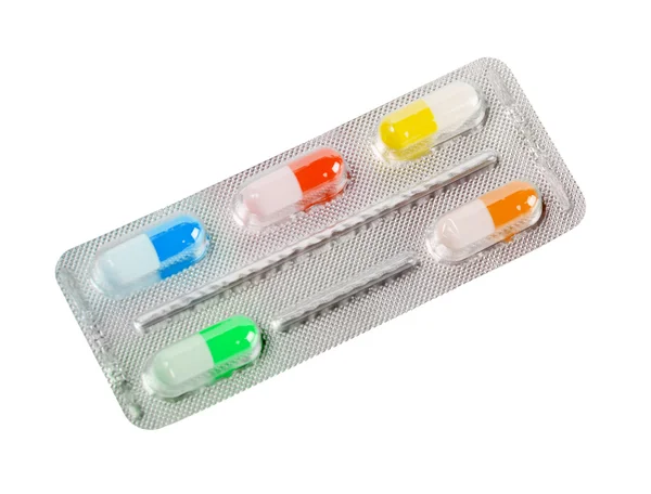 Una ampolla metálica con píldoras de colores — Foto de Stock