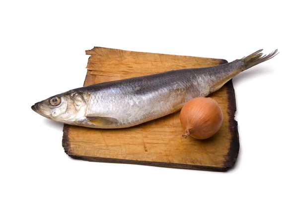 Herring with onion on old wooden board — Photo