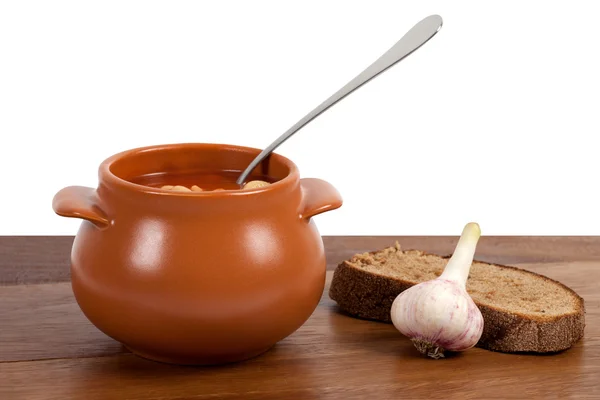 stock image Borsch in clay pot on wooden table