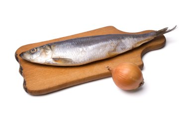 Herring with onion on kitchen board clipart