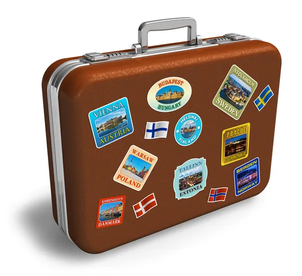 Leather travel suitcase with labels — Stock Photo, Image