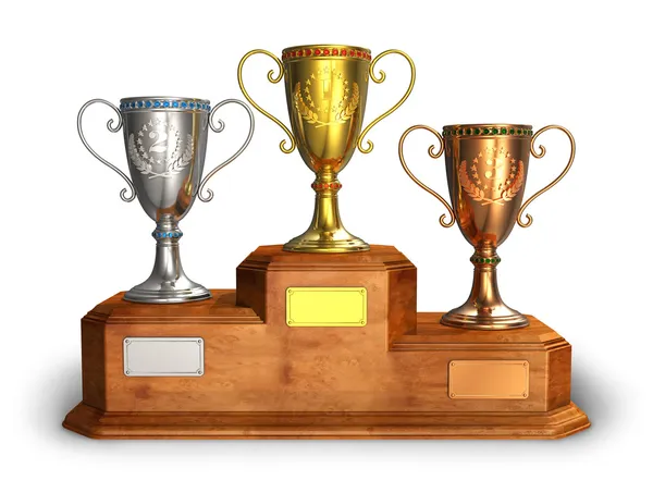 Gold, silver and bronze trophy cups on pedestal — Stock Photo, Image