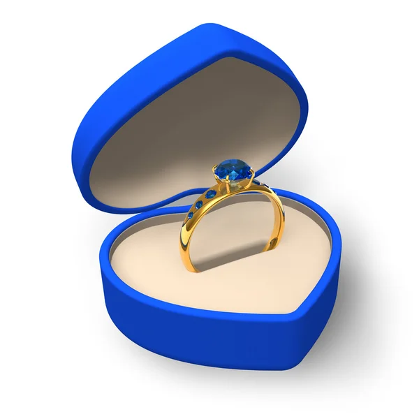 Caixa azul em forma de coração com anel dourado com jóias — Fotografia de Stock
