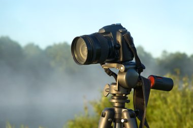 Camera on tripod clipart