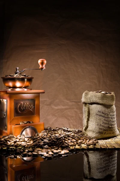 Mill and bag with coffee beans — Stock Photo, Image