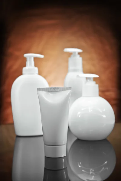Three white cosmetical sprays and tube — Stok fotoğraf