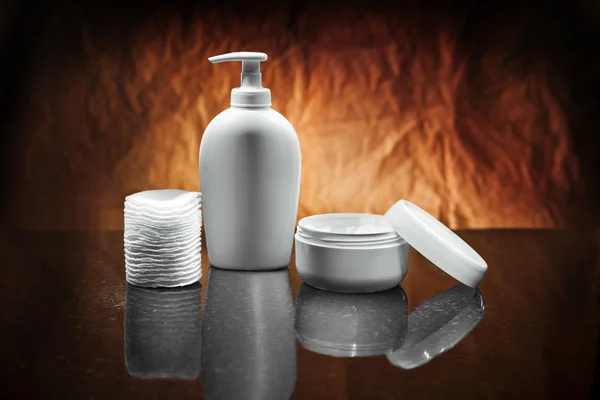 White skincare items on dark background — Stock Photo, Image