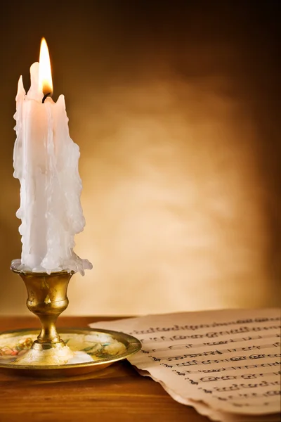 Copy space view on the ablaze candle and old notes — Stock Photo, Image