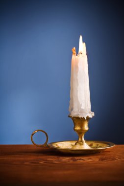 Copy space candle on blue background clipart