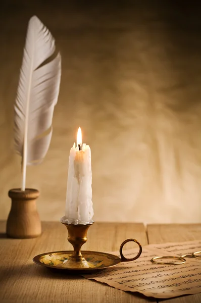 Burning candle in vintage candlestick — Stock Photo, Image