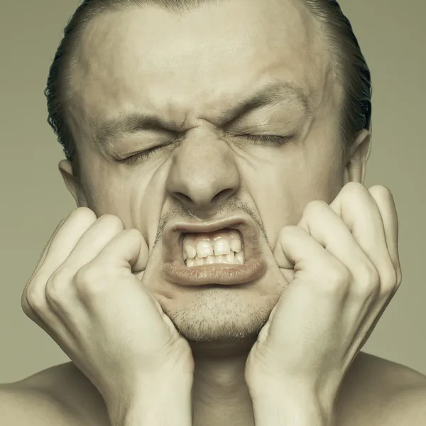 Portrait of a man stretching his face — Stock Photo, Image