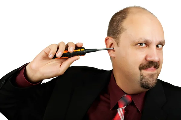 Businessman with screwdriver in the ear — Stock Photo, Image