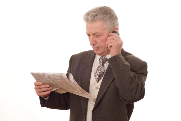 stock image Old man reading a newspaper on white