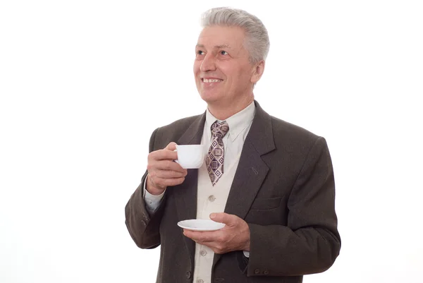 Uomo d'affari che beve da una tazza su un bianco — Foto Stock