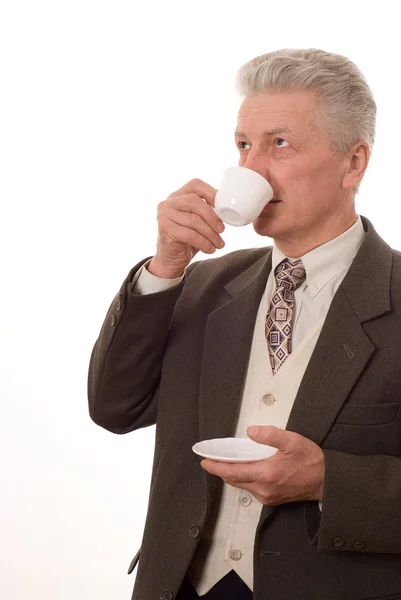 Portrait of a businessman drinking from a cup on a white — Stock Photo, Image