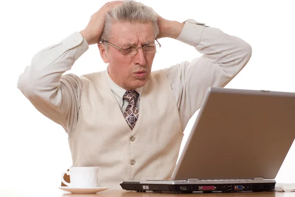 Businessman with laptop holding his head — Stock Photo, Image