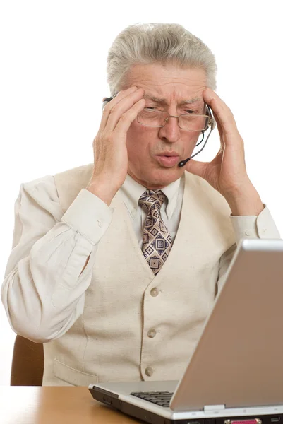 Businessman with laptop holding his head — Stock Photo, Image