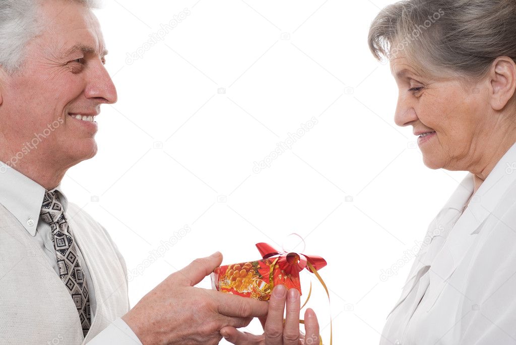 An elderly man gives a lady a gift on a white background