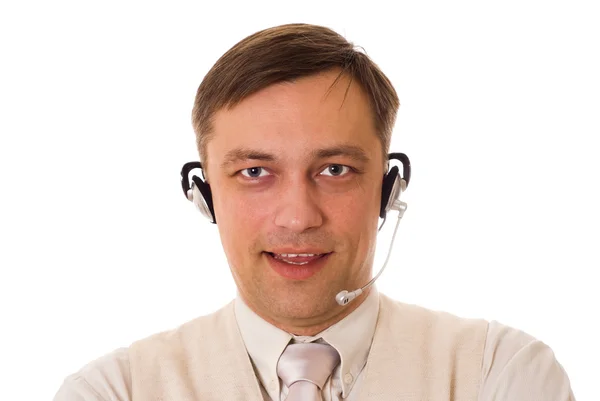Beyaz bir arka plan üzerinde konuşurken kulaklık ile işadamı — Stok fotoğraf