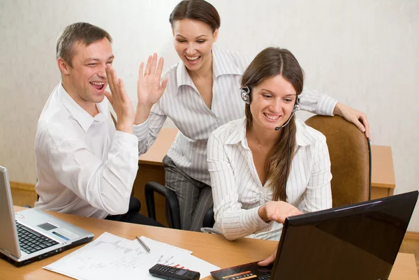 Young businesspeople with the gestures of satisfaction — Stock Photo, Image