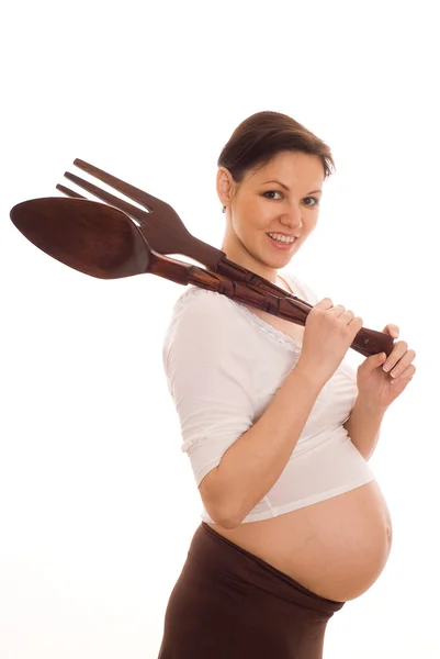 Mujer embarazada sosteniendo cuchara grande y tenedor — Foto de Stock